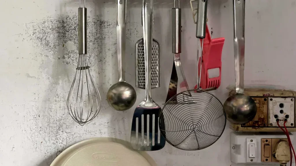Grill tools hanging from storage rack