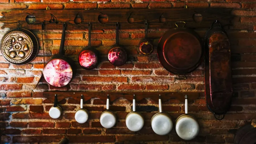 Pots and pans on a wall-mounted rack