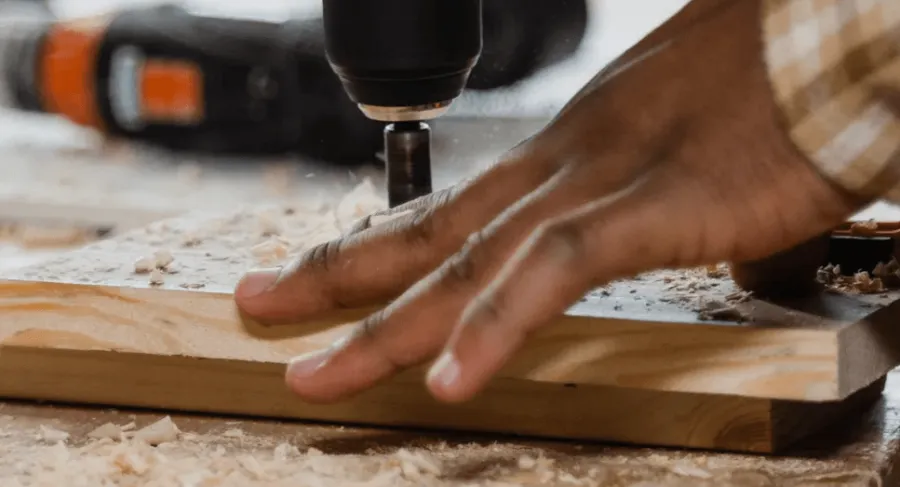 a man using a drill on wood