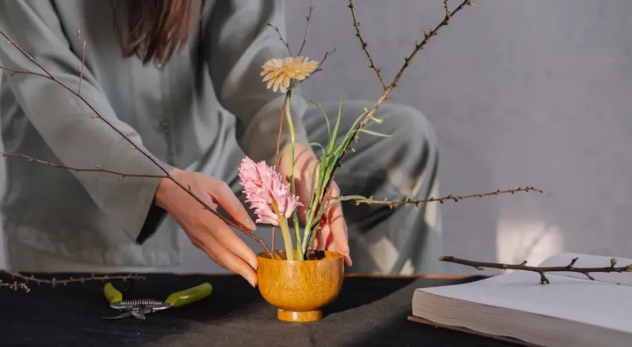 A woman caring for a plant