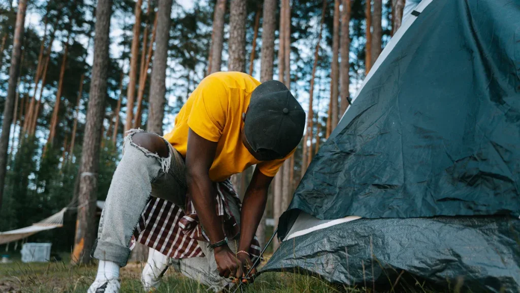 Person setting up a tent