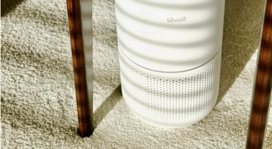An air purifier on a carpeted floor