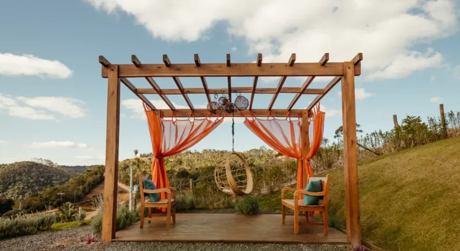 A wooden open gazebo in the hills