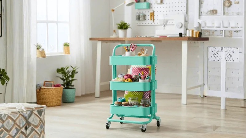 Teal colored multi-level foldable utility cart with stationary essentials