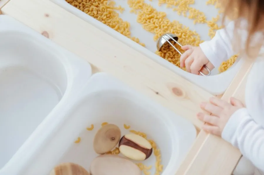 Child Playing In A Sensory Table
