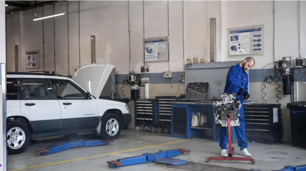 man working in garage with mechanic shop essentials