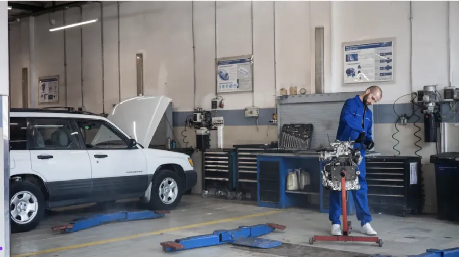 man working in garage with mechanic shop essentials
