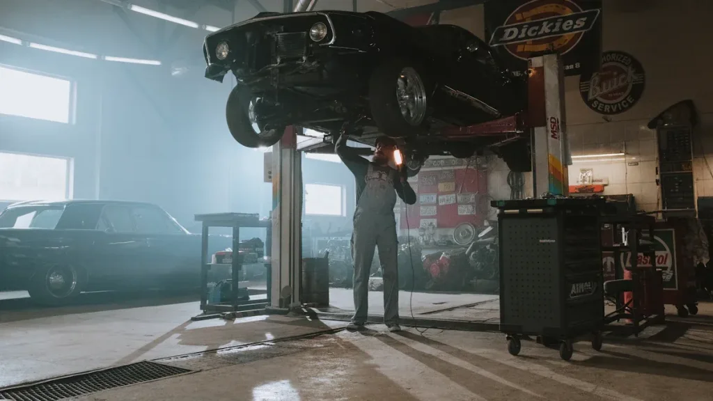 man fixing a car at garage