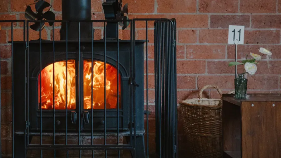 fireplace in front of brick wall