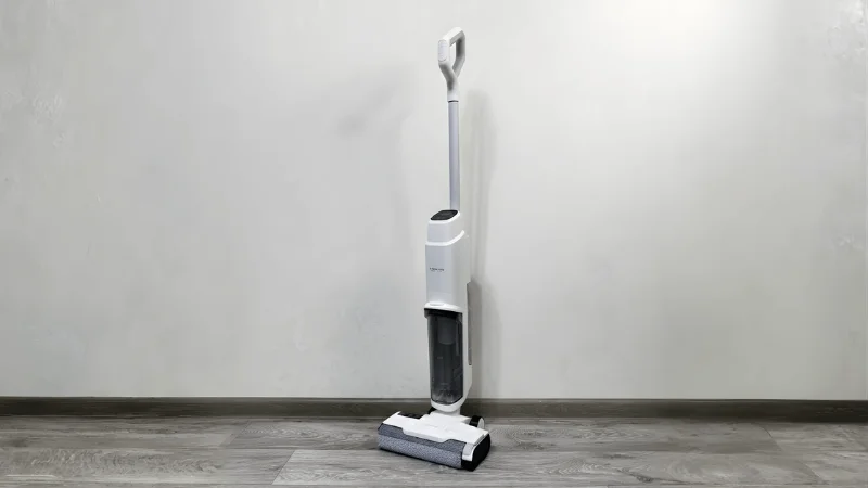 vacuum cleaner placed on a tiled floor next to a wall
