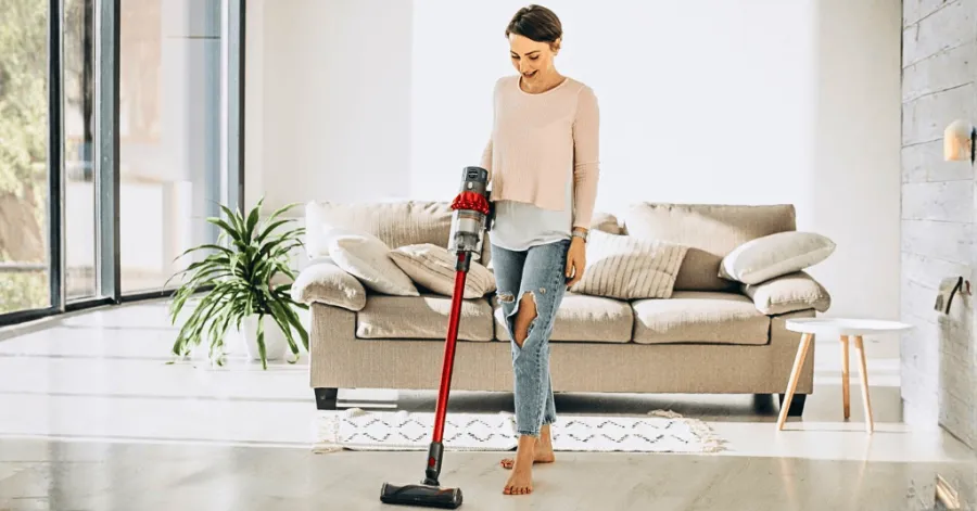 woman cleaning the floor with a portable vacuum cleaner