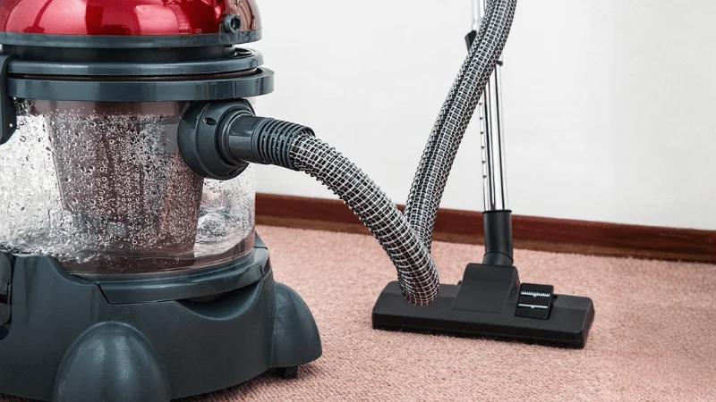A portable vacuum cleaner being used in a household