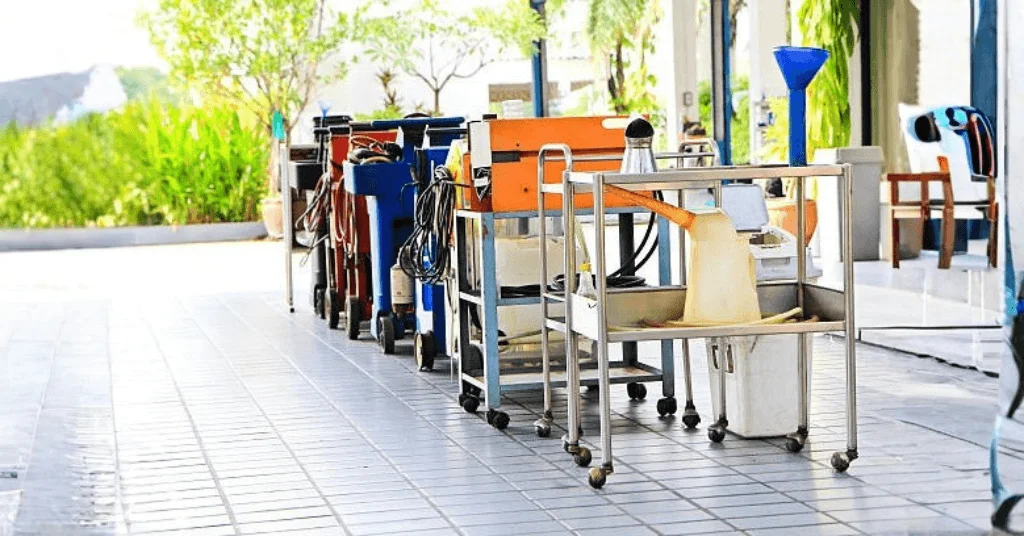 Different utility carts lined up outside a workshop