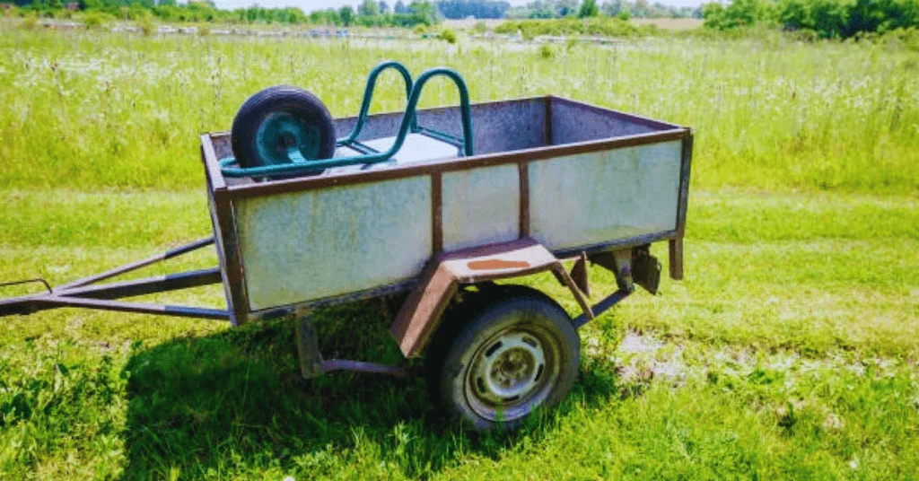 Garden Trailer Dump Cart with a Wheelbarrow loaded onto it