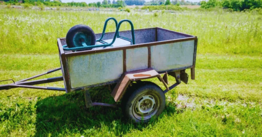 Garden Trailer Dump Cart with a Wheelbarrow loaded onto it