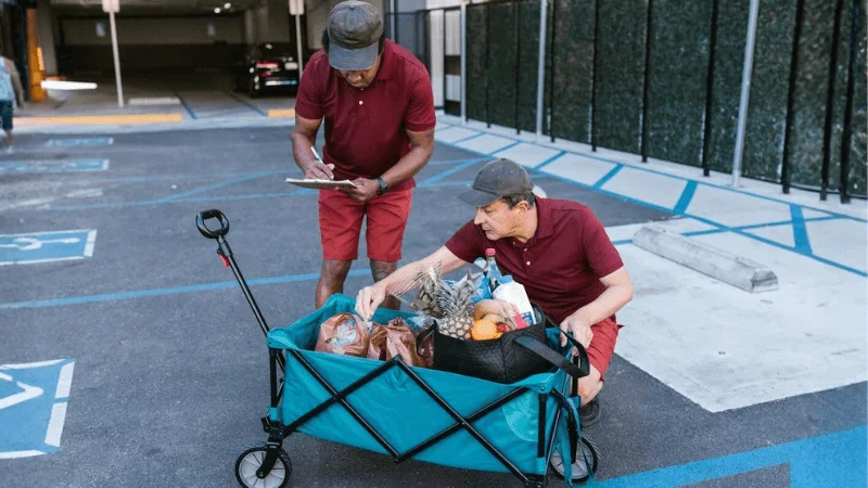 Workers loading items onto a service utility cart