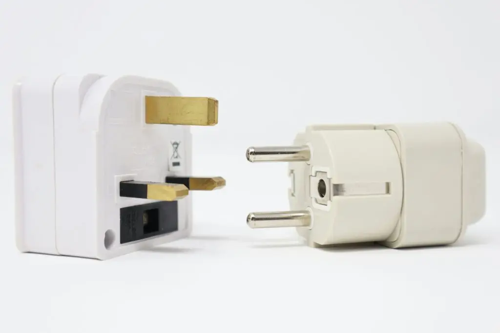 UK three-pin power plug adapter and a European two-pin travel plug