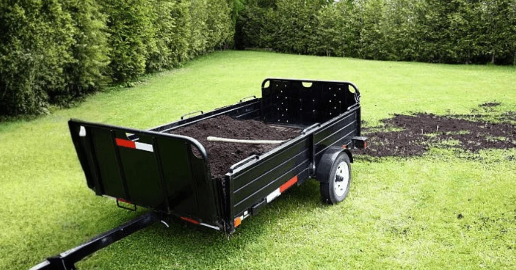 heavy-duty dump trailer with manure loaded onto the bed