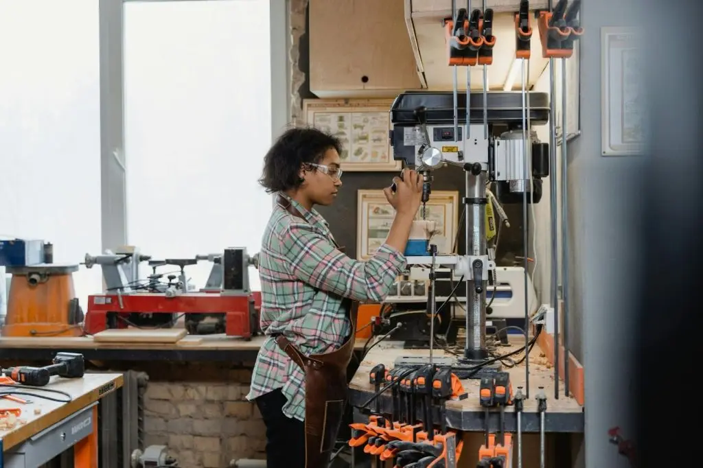 woman using an industrial drill machine