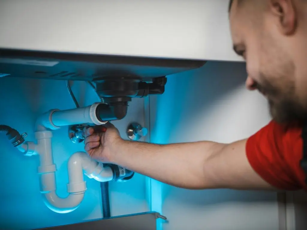 plumber inspecting pipe