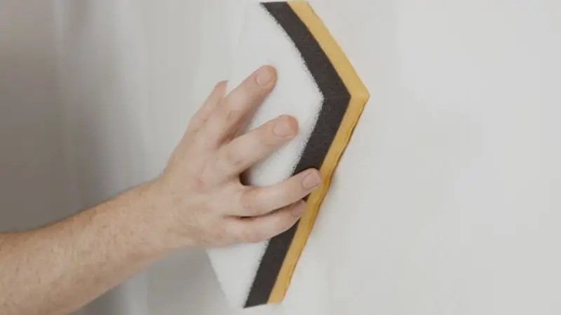 How to minimize dust while sanding a drywall patch