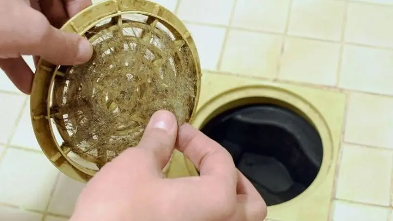 Safely repair a blocked shower drain.