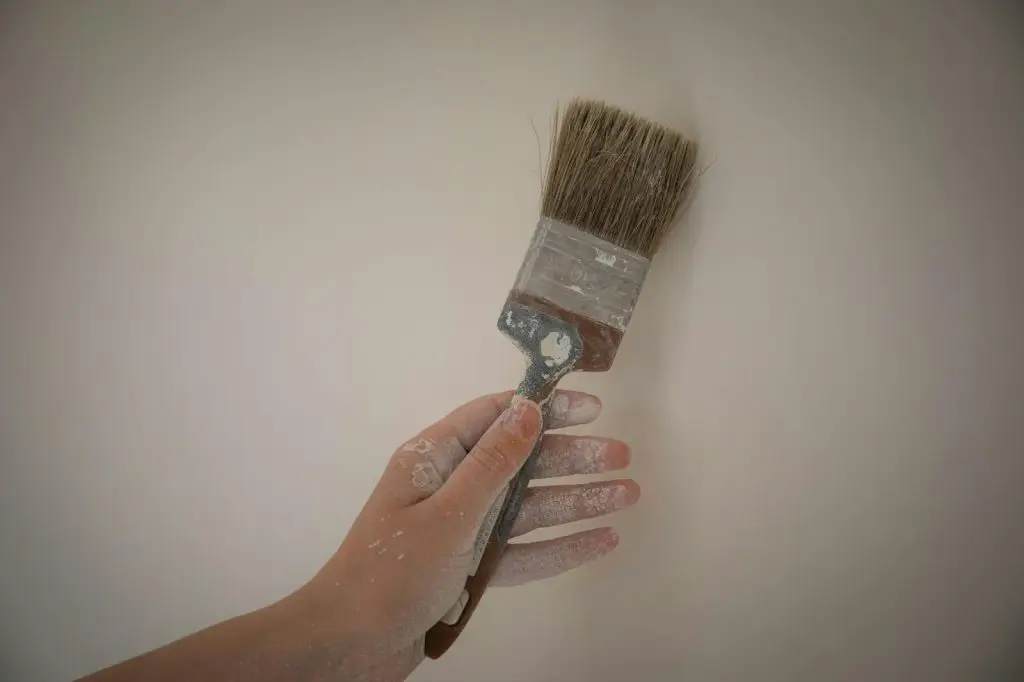 Paint brush against a wall. 