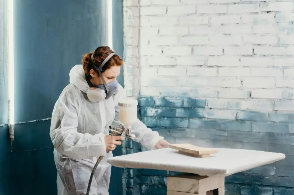 A woman using a professional-grade sprayer