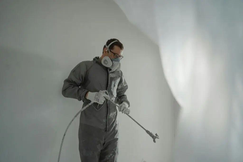 using a spray to paint