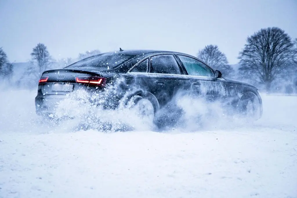 A car drifting sideways through deep snow
