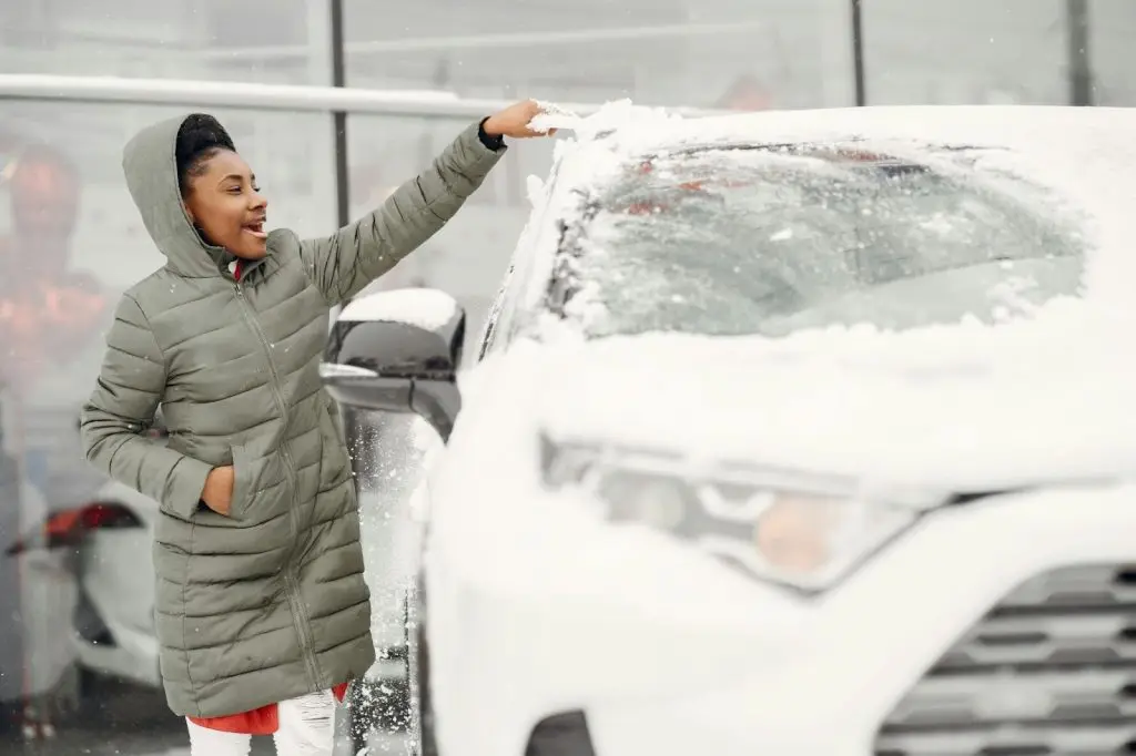 clearing snow on the car