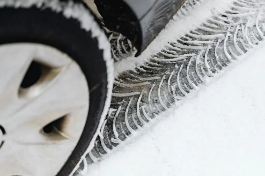 A close-up shot of a winter tire's aggressive tread pattern