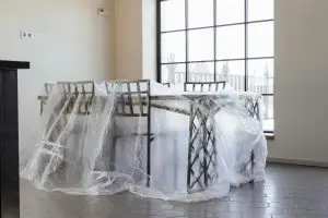 Dining chairs and table covered in plastic