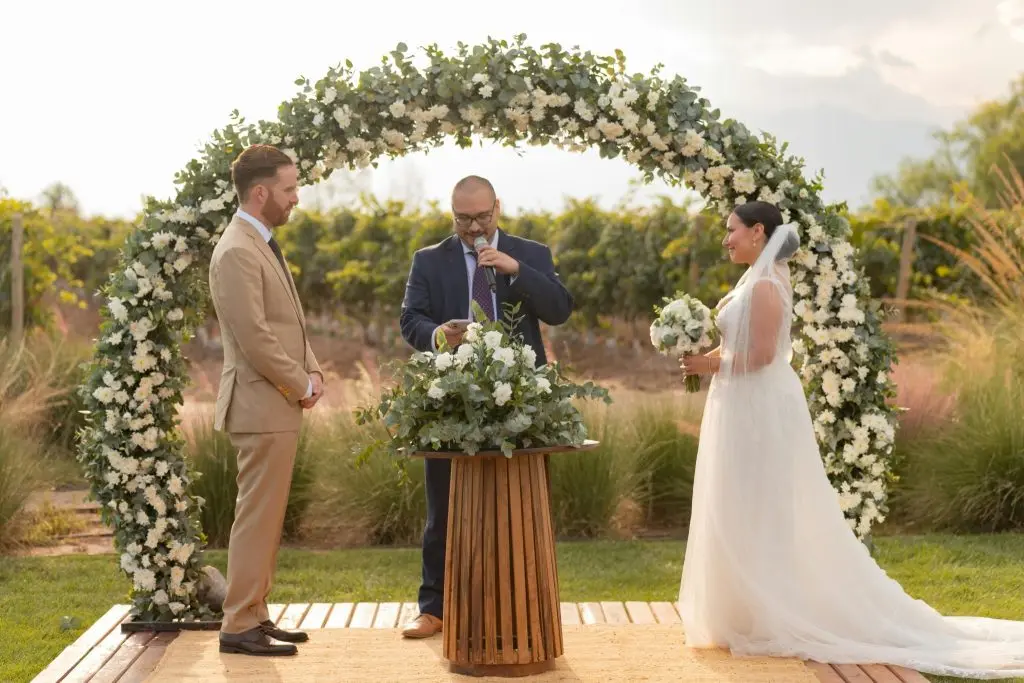 Wedding arch with couple standing by it