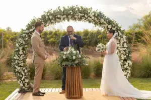 Wedding arch with couple standing by it