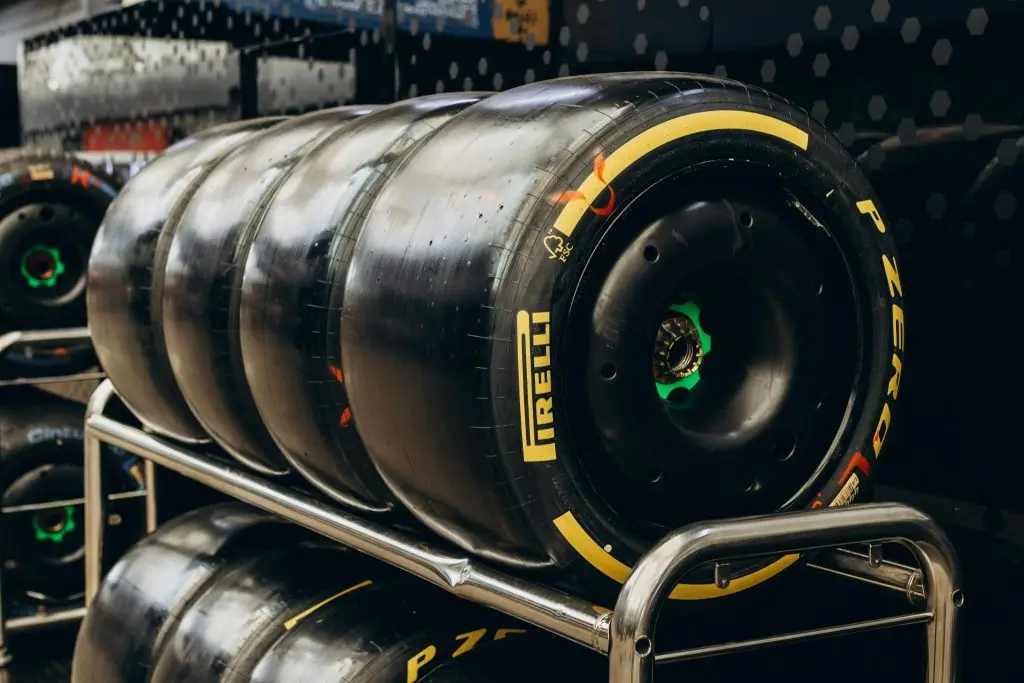 A close-up shot of multiple car tires organized on a metal storage rack.