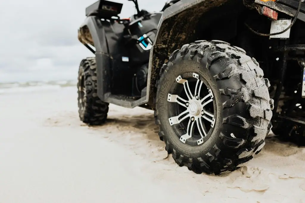 Closeup of a Jeep tire tread gripping a snowy road.