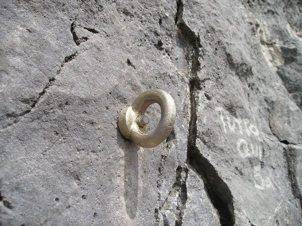 An eye bolt anchored into a rock