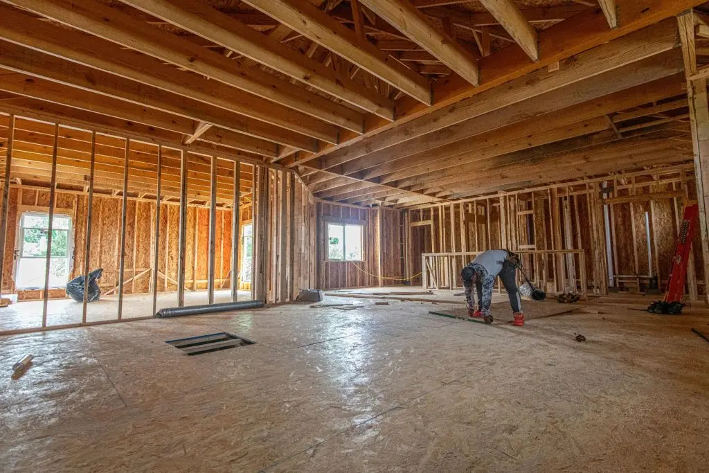 A flooring totally coated with plastic sheeting to form a moisture-proof vapor barrier.