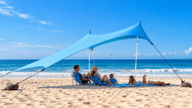 tourist under pop up canopy beach shade