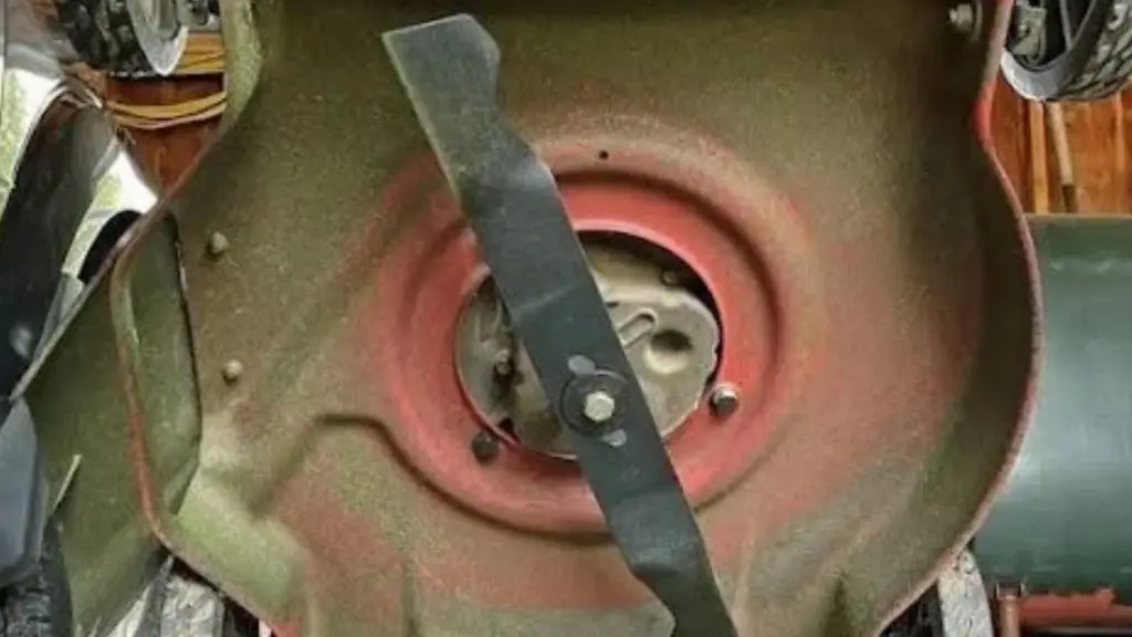 worn mower blade with grass buildup, a sign it needs a proper sharpening angle