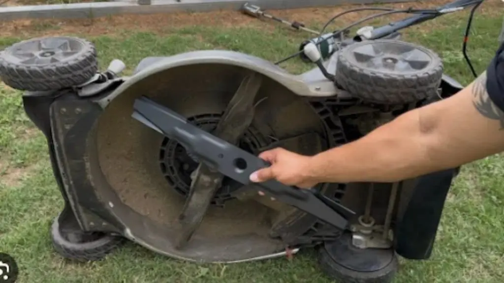 Removing blade from tilted lawn mower