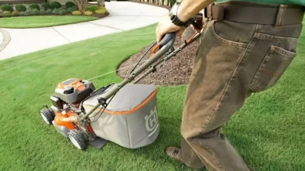 a person mowing with a walk-behind mower whose blade is being ground