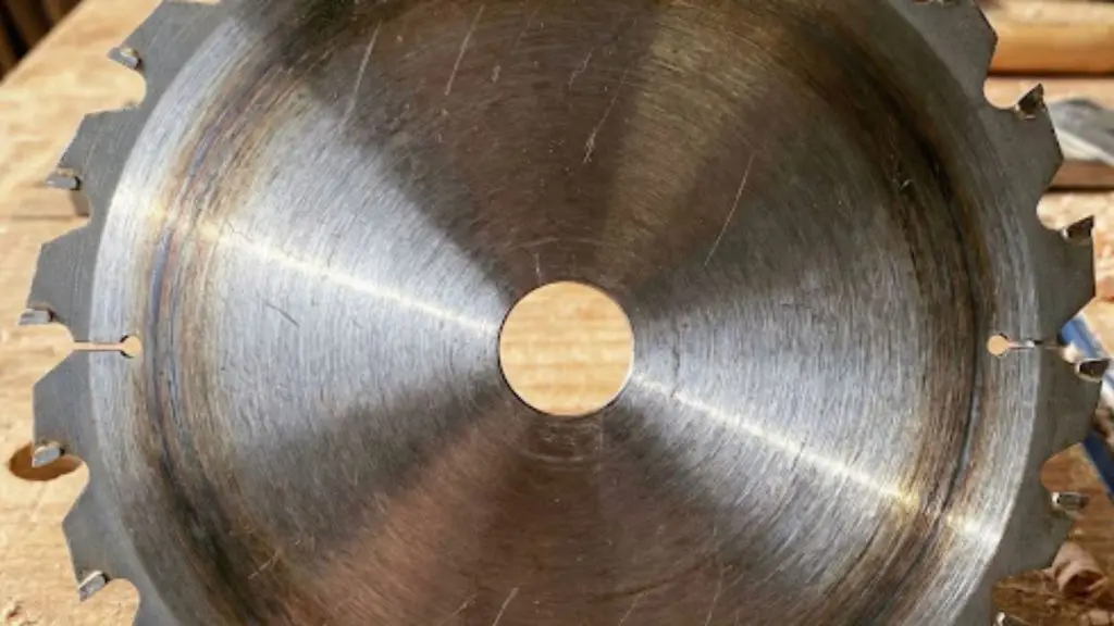 Checking a worn blade before sharpening mulching blades