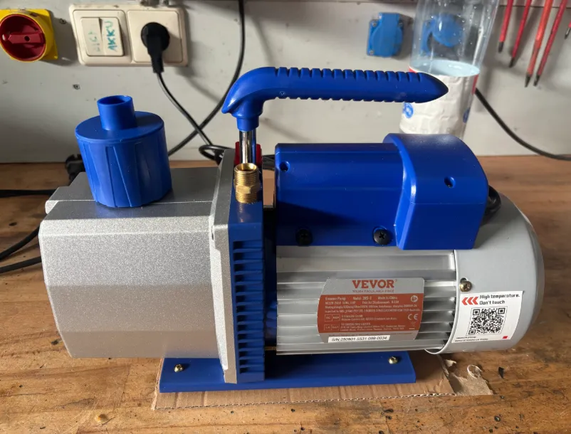 Best vacuum pump: blue VEVOR pump on a workbench