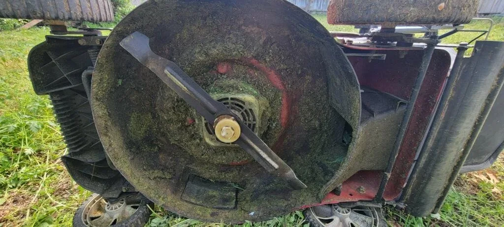 Dull, dirty mower blade before sharpening a lawn mower blade with a bench grinder