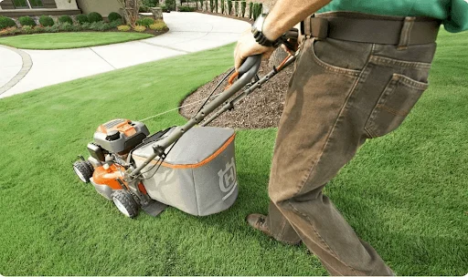 a person mowing with a walk-behind mower whose blade is being ground&nbsp;